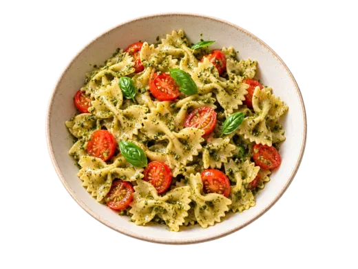 A bowl of basil pesto pasta with cherry tomatoes